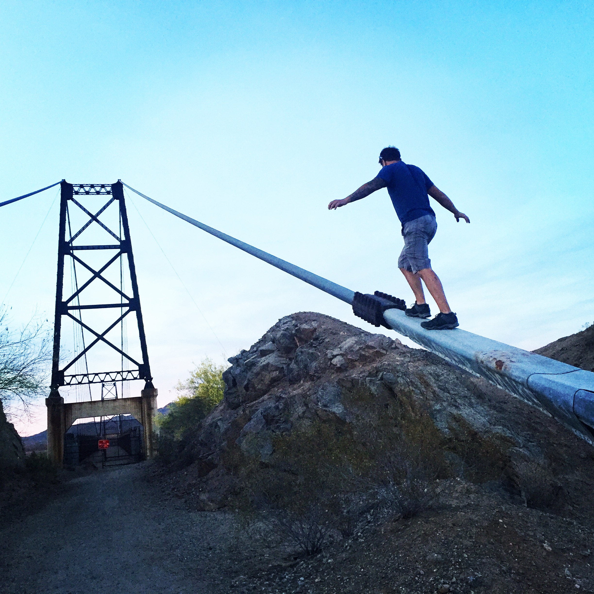 Josh Bolinger clibming a bridge in texas
