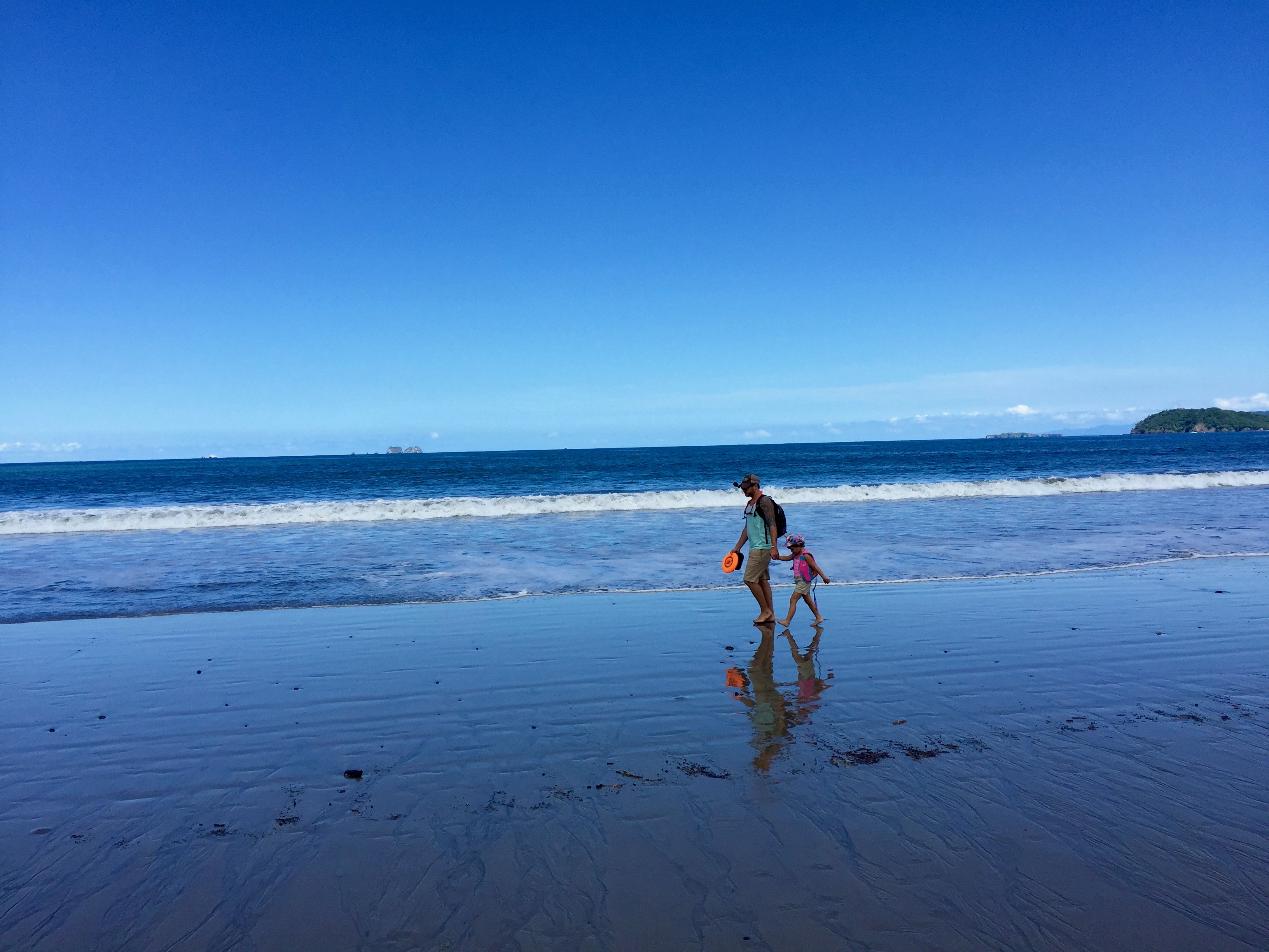 Josh Bolinger and his daughter Suria ont he beach in Costa Rica